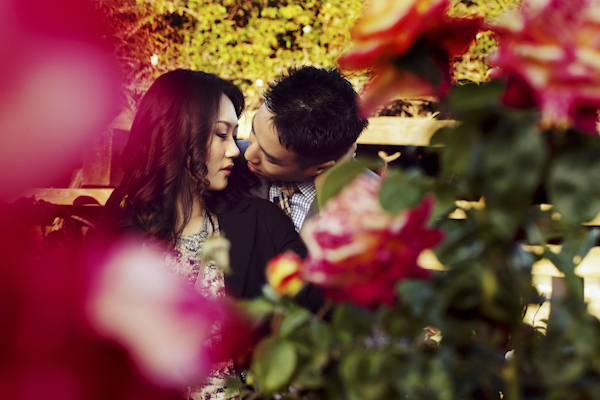 the happy couple cuddling in garden - wedding photo by top Orange County, California wedding photographers D. Park Photography
